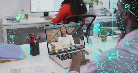 Remote video meeting on laptop in office with digital network overlay and collaboration