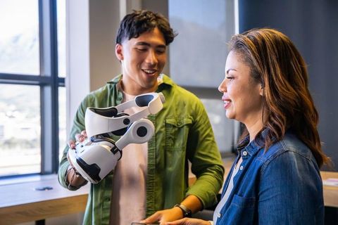 Demonstrating futuristic robotic arm prototype in collaborative modern office