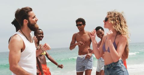Diverse Group of Friends Dancing at Beach in Summer Vibes