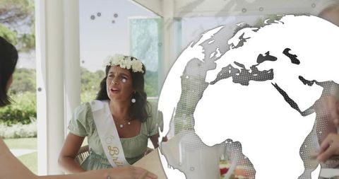 Garden bridal shower with bride-to-be wearing floral crown and sash at pavilion gathering