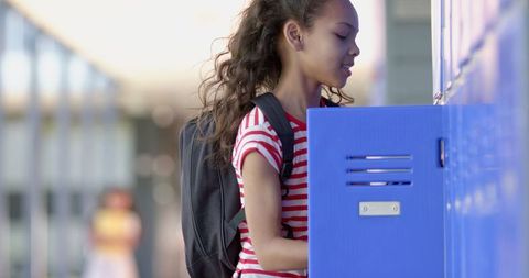 Biracial Student at School Locker in Striped Shirt, Curly Hair