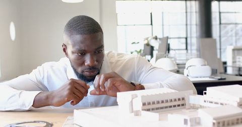 Architect Analyzing Building Model in Modern Office Setting - Download Free Stock Images Pikwizard.com