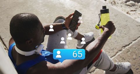 African American Male Athlete Engaging with Fitness and Social Media