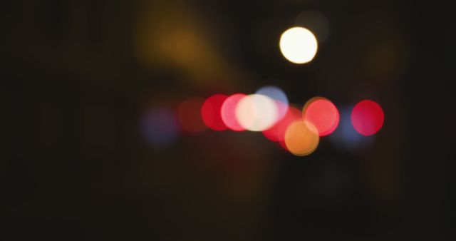 Colorful blurred city lights at night creating a classic bokeh effect. Perfect for backgrounds, wallpapers, website banners, or artistic projects requiring an abstract light theme. Useful for conveying a sense of mystery, urban vibes, or atmospheric mood.
