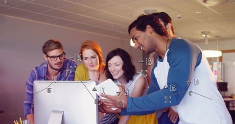 Diverse Coworkers Collaborating Around Computer Screen