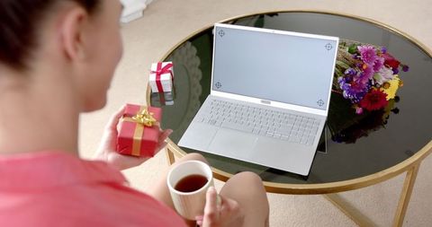 Teen Holding Gift Video Call on Laptop with Complimentary Screen Space
