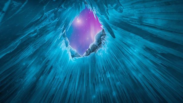 Stunning Ice Cavern with Nebula Through Circular Portal