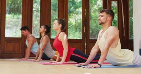 Diverse group practicing yoga indoors enhancing wellness
