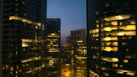 Twin Skyscrapers with Illuminated Windows at Dusk