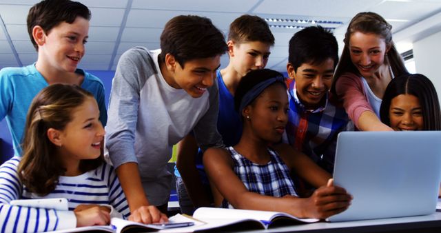 Diverse Group of Teenagers Collaborating on Laptop in Classroom - Download Free Stock Images Pikwizard.com