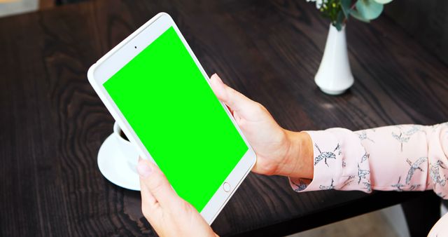 Person Holding Tablet with Green Screen at Coffee Table - Download Free Stock Images Pikwizard.com