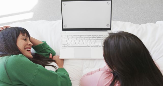 Two Women Enjoying Leisure Time Relaxing at Home with Laptop - Download Free Stock Images Pikwizard.com