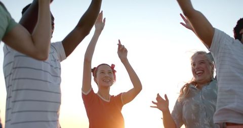 Diverse Friends Celebrating Under Sunset Sky in Slow Motion - Download Free Stock Images Pikwizard.com