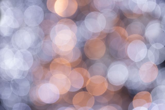 Close up view of purple and orange bokeh spots of light. background with abstract texture concept