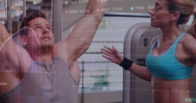 Personal trainer guiding a client during workout in a gym environment, with stock market financial data superimposed on the scene. Ideal for illustrating concepts involving balance between fitness and finance, investor wellbeing, or motivational use in financial industry health campaigns.