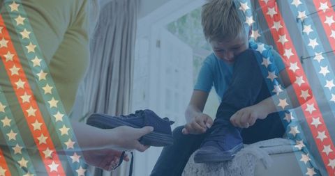 Mother Helping Son to Tie Shoes with Patriotic Stars and Stripes
