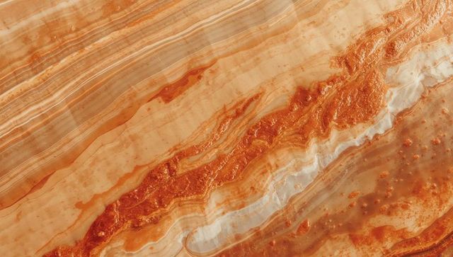 Polished banded stone with wavy orange and beige striations