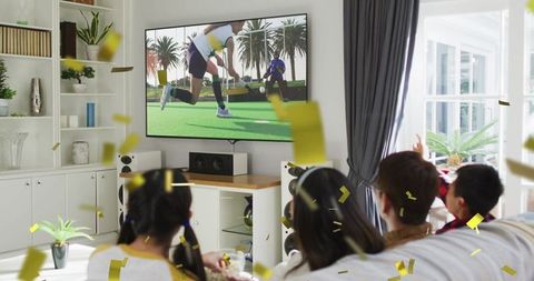 Family Watching TV with Exciting Confetti Celebration