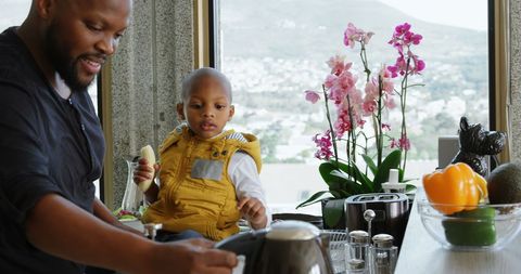 Father Pouring Coffee with Son in Modern Kitchen