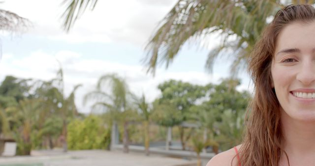 Smiling Woman Outdoors Near Palm Trees on a Sunny Day - Download Free Stock Images Pikwizard.com