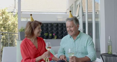 Senior Couple Joyfully Celebrating Birthday with Wine and Gifts