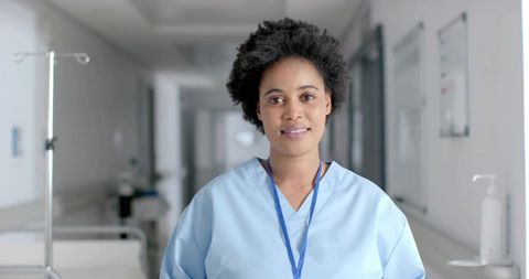 Dedicated Nurse in Hospital Corridor with Medical Equipment