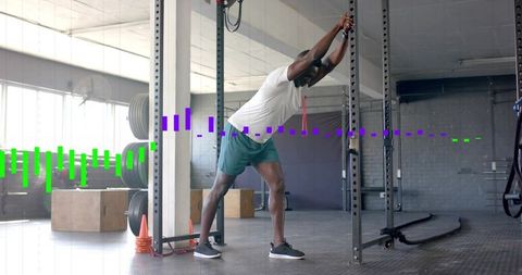 Athlete stretching on squat rack in industrial gym with weight plates and waveform overlay