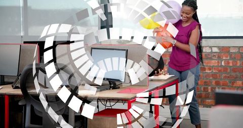 Office teammate celebrating birthday with balloons and lit cake in open-plan workspace