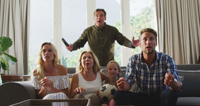 Family Excitedly Watching Sports Game Together on Television - Download Free Stock Images Pikwizard.com