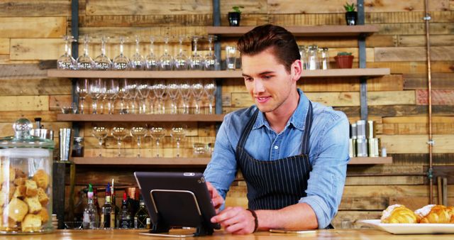 Young Barista Using Tablet Device in Rustic Cafe - Download Free Stock Images Pikwizard.com