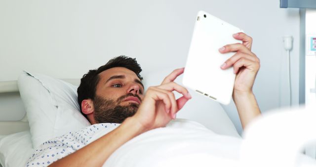 Young Man Lying in Hospital Bed Using Digital Tablet - Download Free Stock Images Pikwizard.com