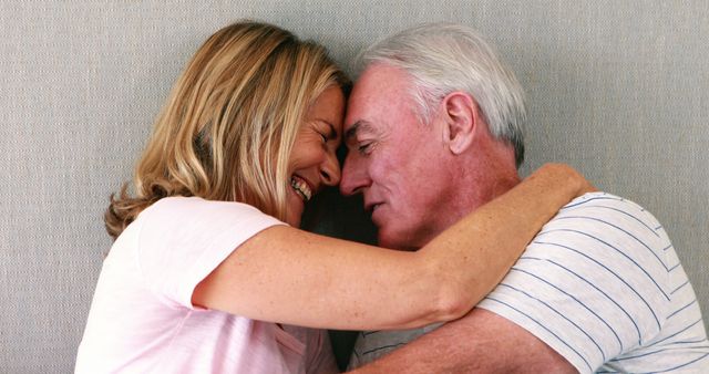 Happy Senior Couple Embracing and Laughing Together Indoors - Download Free Stock Images Pikwizard.com