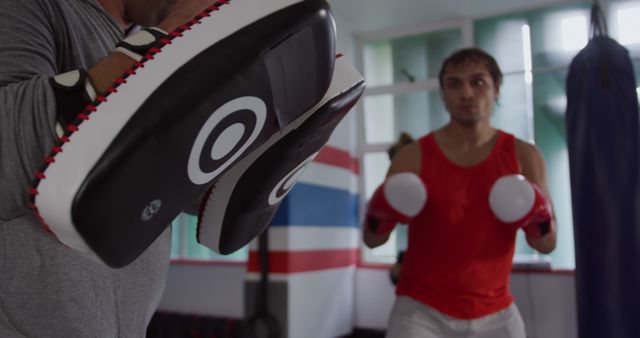 Boxer Practicing Punches in Gym with Coach - Download Free Stock Images Pikwizard.com