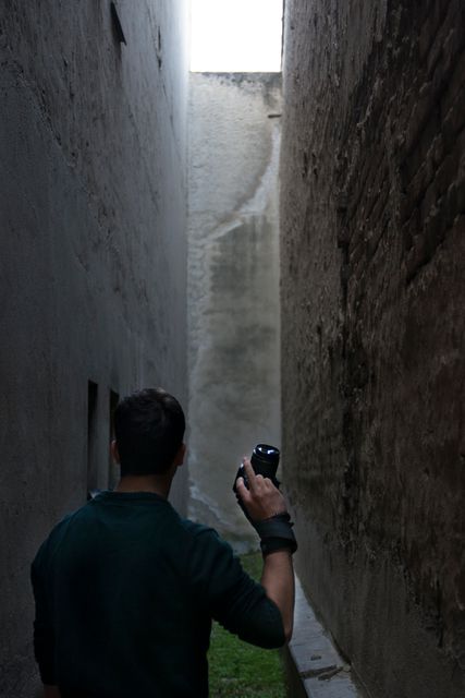 Photographer Exploring Narrow Urban Alley with Camera - Download Free Stock Images Pikwizard.com