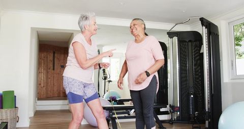 Senior women enjoying workout together in home gym