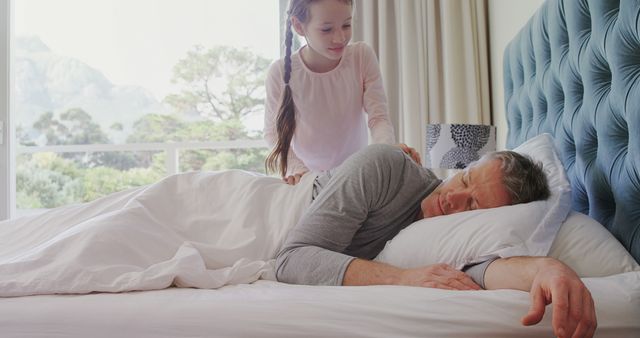 Young daughter gently waking up father in cozy bedroom - Download Free Stock Images Pikwizard.com