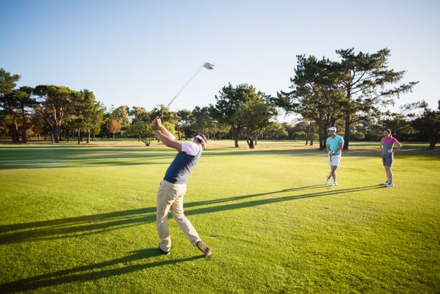 Group of friends enjoying a game of golf on a sunny day. Perfect for promoting outdoor activities, sports events, and leisure time. Ideal for advertisements related to golf courses, sportswear, and fitness.