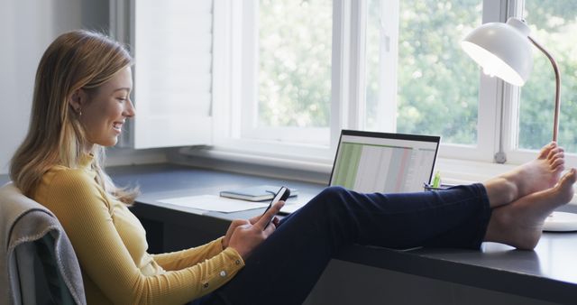 Relaxed Woman Working from Home with Phone and Laptop - Download Free Stock Images Pikwizard.com