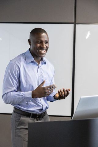 Smiling professional presenting ideas in modern office setting