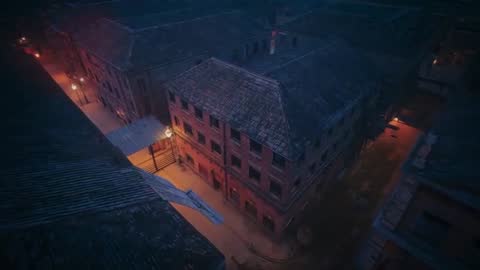 Aerial View of Historic Red Brick Building at Night with Warm Lights