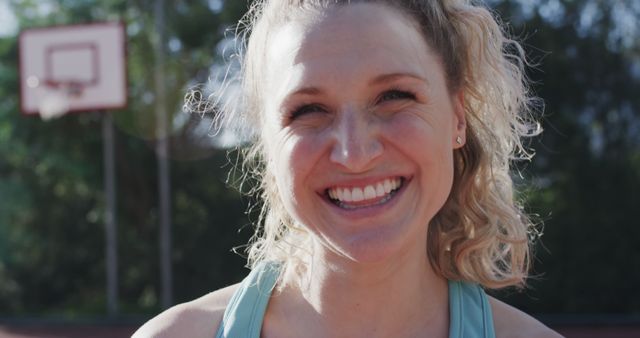 Happy Woman Smiling Outdoors at Basketball Court - Download Free Stock Images Pikwizard.com