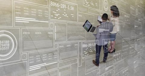 Business professionals discussing data with laptops and tablets in atrium ar interface