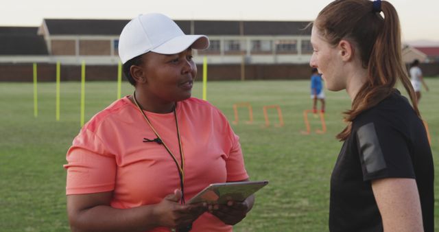 Coach Giving Instructions to Female Soccer Player on Training Field - Download Free Stock Images Pikwizard.com