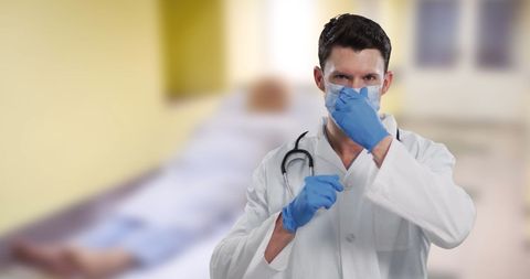 Caucasian Male Doctor Putting On Mask in Hospital Room - Download Free Stock Images Pikwizard.com