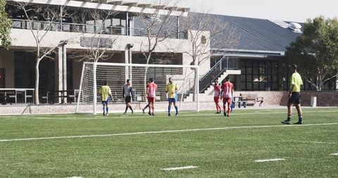 Soccer players preparing penalty on school field