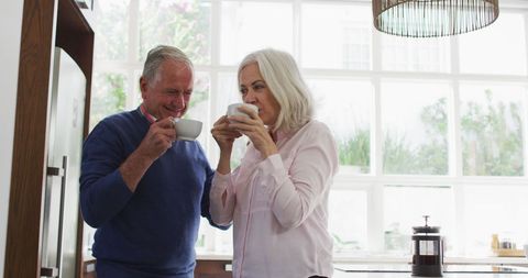 Senior Couple Enjoying Coffee in Bright Kitchen