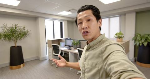 Businessman recording video in modern office space