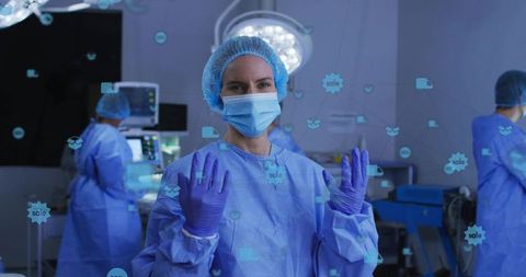 Preparing surgeon wearing blue gown and purple gloves raising hands in operating room hud