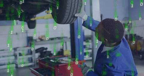 Automotive technician inspecting lifted tire with binary overlay for smart diagnostics