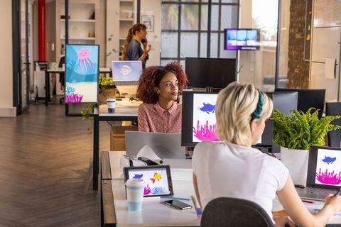 Creative Female Colleagues and Sea Life Design in Modern Office
